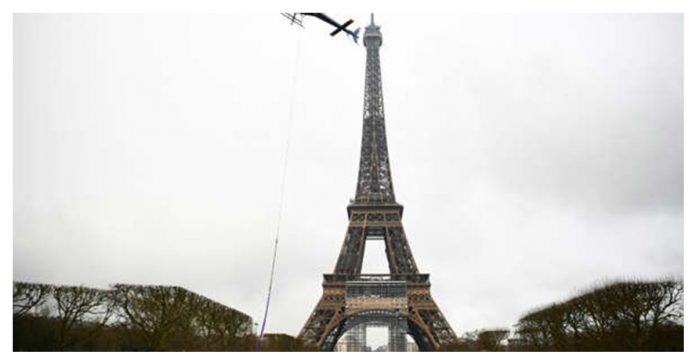 Technicians in Paris add an antenna